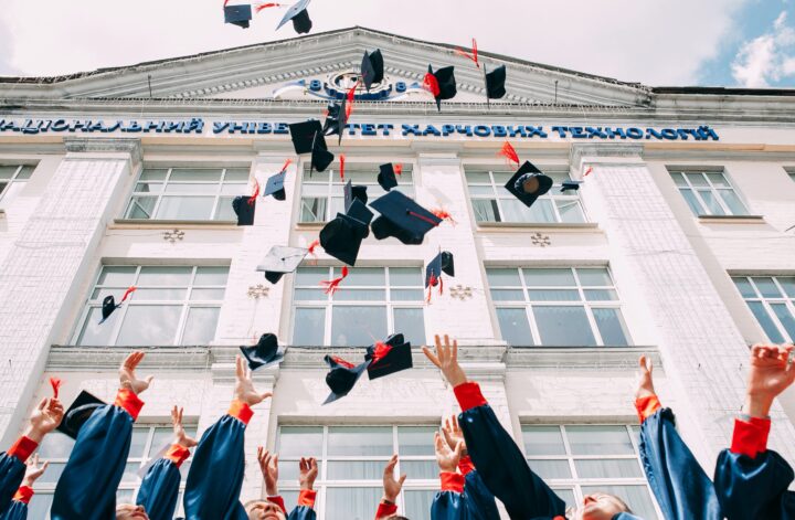 graduates throwing up their caps
